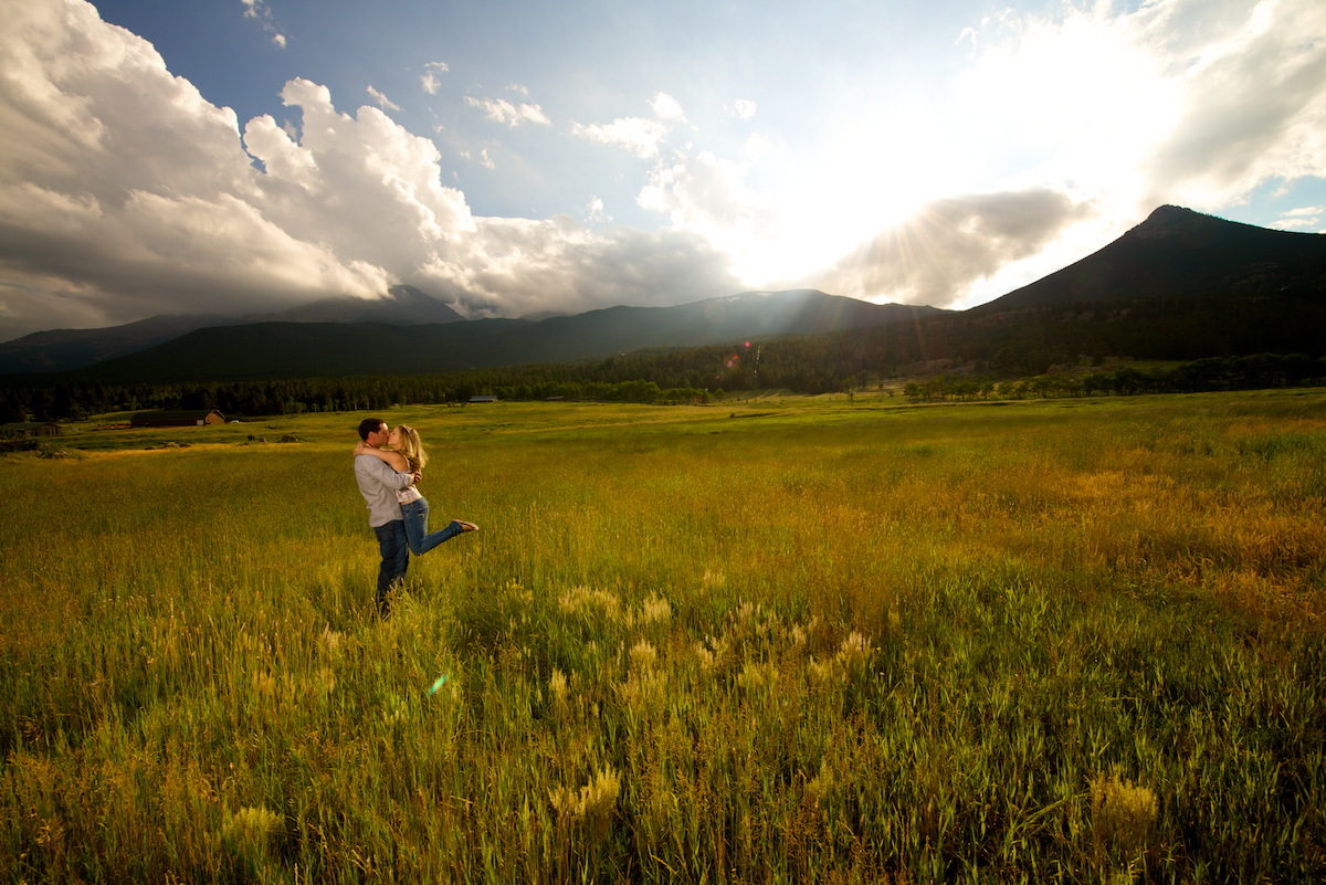 Lily Lake Estes Park Colorado Engagement Pictures in Field Kissing