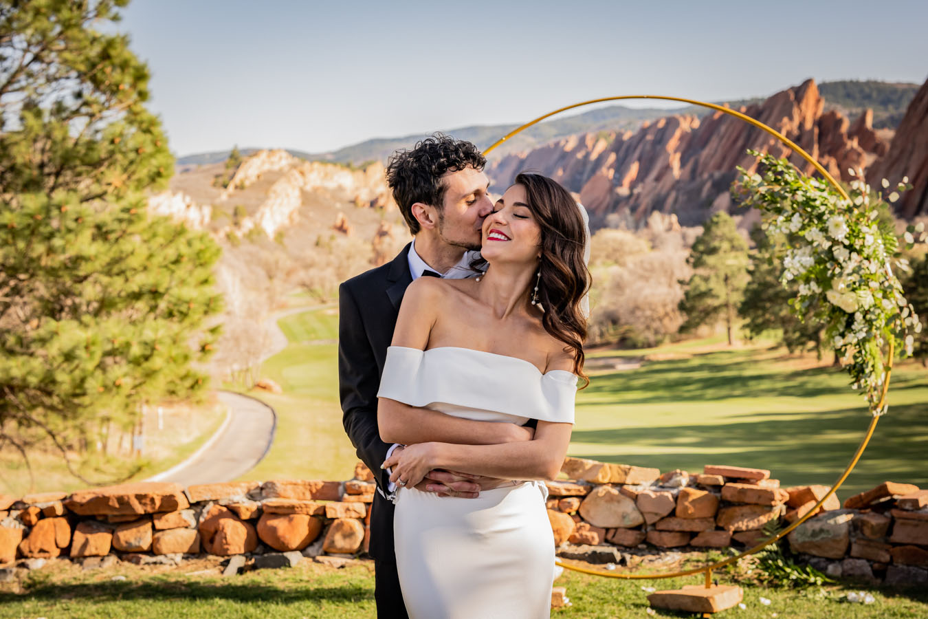 Kiss on the Brides Cheek at the Arrowhead Golf Club